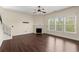 Bright living room featuring hardwood floors, a fireplace, and natural light from large windows at 2238 Well Springs Dr, Buford, GA 30519