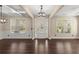 Bright living room showcasing wood floors, white trim, and abundant natural light through large windows at 2238 Well Springs Dr, Buford, GA 30519