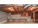 Spacious basement with exposed ceiling and block walls, featuring tables for various uses at 2261 Byron Sw Ct, Marietta, GA 30064