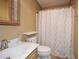 Tan bathroom includes marble countertops, toilet, and a shower with curtain at 2261 Byron Sw Ct, Marietta, GA 30064