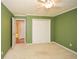 This bedroom features neutral carpet, pale-green walls, and a ceiling fan with overhead lighting at 2261 Byron Sw Ct, Marietta, GA 30064