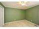 This bedroom features neutral carpet, pale-green walls, and a ceiling fan with overhead lighting at 2261 Byron Sw Ct, Marietta, GA 30064