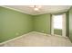 Carpeted bedroom with green walls, white trim, ceiling fan, and window with light filtering curtains at 2261 Byron Sw Ct, Marietta, GA 30064