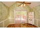 Bright dining area with wood floors, ceiling fan, wainscoting and sliding glass doors to the deck at 2261 Byron Sw Ct, Marietta, GA 30064