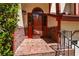 Inviting brick-paved front entrance with a classic red door, stylish outdoor lighting, and established greenery at 2261 Byron Sw Ct, Marietta, GA 30064