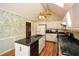 This kitchen features an island, granite countertops, updated appliances, wooden floors, and a ceiling fan at 2261 Byron Sw Ct, Marietta, GA 30064