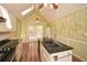 Open kitchen with island, granite counters, wood floors, stainless steel appliances, ceiling fan and patio access at 2261 Byron Sw Ct, Marietta, GA 30064