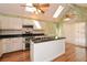 Bright kitchen boasts an island, stainless appliances, double oven, wooden floors, and a sliding glass door at 2261 Byron Sw Ct, Marietta, GA 30064