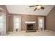 Bright living room with a cozy brick fireplace, vaulted ceilings, and large windows for ample natural light at 2261 Byron Sw Ct, Marietta, GA 30064