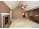 Open living room featuring a fireplace, vaulted ceiling, and seamless transition to the dining area at 2261 Byron Sw Ct, Marietta, GA 30064