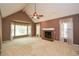 Spacious living room featuring a vaulted ceiling, brick fireplace, and large windows with decorative curtains at 2261 Byron Sw Ct, Marietta, GA 30064