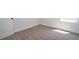 A clean, carpeted room with sunlight streaming through a window and a white door at 4956 Villager Ln, Stone Mountain, GA 30083