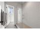 Walk-in shower with subway tile, open door to the bathroom, and grey tile flooring at 558 Bismark Ne Rd, Atlanta, GA 30324