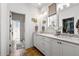 Bright bathroom with double sinks, marble countertops, and a glass-enclosed shower at 558 Bismark Ne Rd, Atlanta, GA 30324