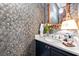 Stylish powder room showcasing bold peacock wallpaper, a marble countertop, and a decorative mirror at 558 Bismark Ne Rd, Atlanta, GA 30324