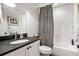 Stylish bathroom featuring a black granite countertop and a black and white shower curtain at 558 Bismark Ne Rd, Atlanta, GA 30324