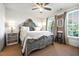 Charming bedroom with a decorative bed frame, ample natural light, and neutral carpeting at 558 Bismark Ne Rd, Atlanta, GA 30324