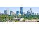 View of a vibrant city skyline beyond a lush canopy of green trees in daytime at 558 Bismark Ne Rd, Atlanta, GA 30324
