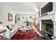 Elegant living room with fireplace, modern art, and open layout into dining and kitchen areas at 558 Bismark Ne Rd, Atlanta, GA 30324