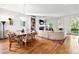 Open-concept living room with hardwood floors, fireplace, built-in shelves, and sun-filled windows at 558 Bismark Ne Rd, Atlanta, GA 30324