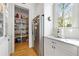 Spacious pantry with stocked shelves and storage baskets adjacent to the stainless steel refrigerator at 558 Bismark Ne Rd, Atlanta, GA 30324