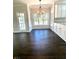 Bright dining area with granite countertops, white cabinets, and dark wood floors at 180 Shyrewood Dr, Lawrenceville, GA 30043