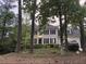 Charming two-story home with black shutters and a well-maintained lawn, partially obstructed by trees at 180 Shyrewood Dr, Lawrenceville, GA 30043