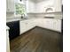 Kitchen featuring white cabinets, dark hardware and granite countertops at 180 Shyrewood Dr, Lawrenceville, GA 30043