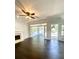 Open-concept living room with dark wood floors, fireplace, and large windows for natural light at 180 Shyrewood Dr, Lawrenceville, GA 30043