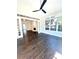 Light-filled room with dark wood floors, large windows, and an open view to other living areas at 180 Shyrewood Dr, Lawrenceville, GA 30043