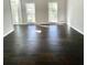 Spacious room with dark wood floors, flooded with natural light through large windows at 180 Shyrewood Dr, Lawrenceville, GA 30043