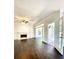 Bright living room with dark wood floors, fireplace, and french doors to the outside at 180 Shyrewood Dr, Lawrenceville, GA 30043