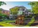 Large backyard featuring a playground, lush lawn, and manicured landscaping, perfect for outdoor activities at 2270 Abbey Cove Ct, Marietta, GA 30062