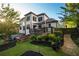 Spacious backyard featuring a deck, patio, lush landscaping, and a charming stone path at 2270 Abbey Cove Ct, Marietta, GA 30062