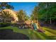 Well-manicured backyard with a custom playset, lush lawn, and mulched garden beds, creating a fun and inviting outdoor space at 2270 Abbey Cove Ct, Marietta, GA 30062