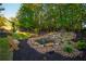 Backyard pond with a rock waterfall and lush plantings, creating a tranquil and picturesque water feature in the landscape at 2270 Abbey Cove Ct, Marietta, GA 30062