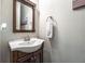 Powder room with dark wood vanity and framed mirror at 2270 Abbey Cove Ct, Marietta, GA 30062