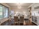 Well-lit dining room with modern lighting, seating for six, and neutral wall color at 2270 Abbey Cove Ct, Marietta, GA 30062