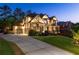 Stunning two-story home with brick and stone exterior, manicured lawn, and three-car garage at 2270 Abbey Cove Ct, Marietta, GA 30062