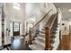 Two-story foyer featuring hardwood floors, carpeted stairs, and decorative lighting at 2270 Abbey Cove Ct, Marietta, GA 30062