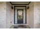 Charming front door of a brick home, complemented by a decorative wreath and 'Home Sweet Home' mat at 2270 Abbey Cove Ct, Marietta, GA 30062