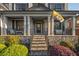 Inviting front porch with decorative columns, stone accents, and an iron railing staircase leading to the entrance at 2270 Abbey Cove Ct, Marietta, GA 30062