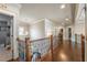 Second story hallway boasts hardwood floors and wood and iron railings at 2270 Abbey Cove Ct, Marietta, GA 30062
