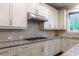Close-up of kitchen featuring granite counters, stainless steel appliances, and tiled backsplash at 2270 Abbey Cove Ct, Marietta, GA 30062