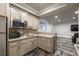 Stylish kitchenette boasts granite counters, stainless appliances, and ample cabinet space, open to living area at 2270 Abbey Cove Ct, Marietta, GA 30062
