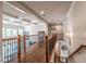 Upstairs landing with hardwood floors, iron railing, and views of the downstairs living area at 2270 Abbey Cove Ct, Marietta, GA 30062