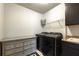 Well-organized laundry room with modern washer and dryer, shelving, and cabinet storage at 2270 Abbey Cove Ct, Marietta, GA 30062