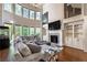 Bright, open living room with large windows, fireplace, and comfortable gray sectional sofa at 2270 Abbey Cove Ct, Marietta, GA 30062
