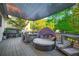 Large outdoor patio with a shade covering, dining table, outdoor seating, and grill area at 2270 Abbey Cove Ct, Marietta, GA 30062