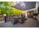 Outdoor patio featuring a shade covering, dining table, outdoor TV, and lush greenery at 2270 Abbey Cove Ct, Marietta, GA 30062